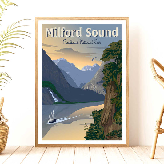 A framed travel poster depicting Milford Sound, showing the Fiordland National Park with mountains, water, and a boat, styled in a vintage travel poster aesthetic.